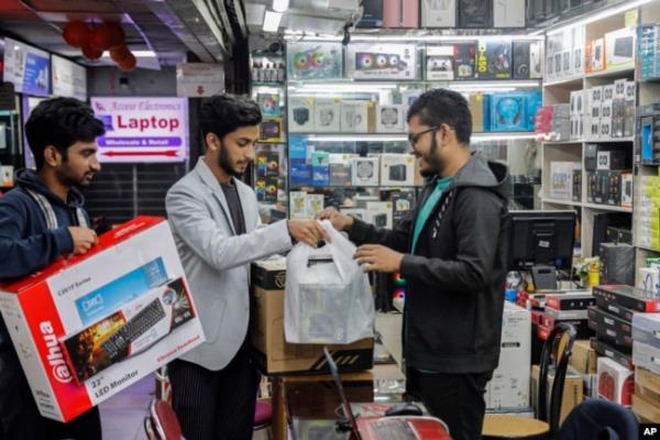 FILE - Customers buy computers and other digital accessories at a computer market in Dhaka, Bangladesh, Jan. 1, 2024. Recent high inflation has seriously slowed demand and co<em></em>nsumption in the country.